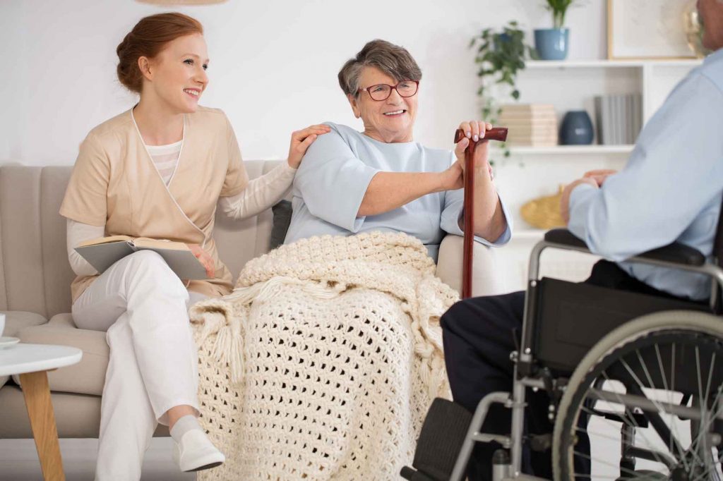 Private nurse taking care of elderly patient in their home.